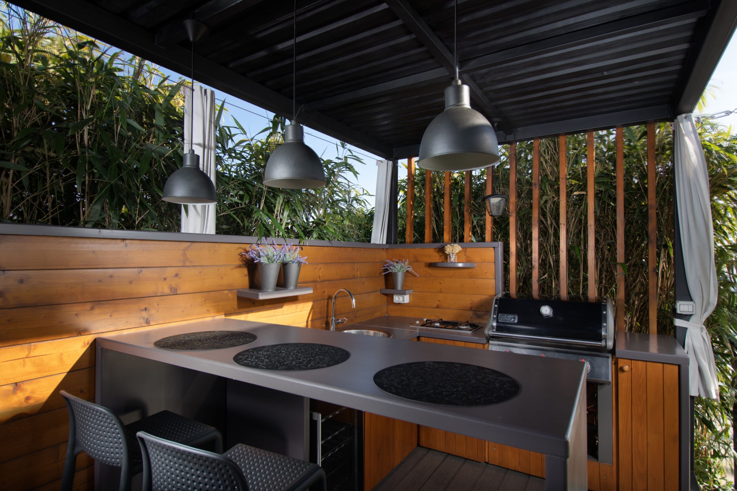 Ginter Services | Home An open-air mini kitchen with wooden parts, trees and sky background